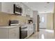 Clean kitchen featuring white cabinets and stainless steel appliances at 7803 Cadillac Ave, Hudson, FL 34667
