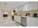Modern kitchen with white cabinets and stainless steel appliances at 7803 Cadillac Ave, Hudson, FL 34667