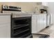 Stainless steel appliances and white cabinetry in this kitchen at 7803 Cadillac Ave, Hudson, FL 34667