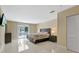 Large main bedroom with tiled floors and access to a balcony at 7803 Cadillac Ave, Hudson, FL 34667