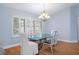 Dining area with glass-top table, white chairs, and a chandelier at 810 Sandringham Ln, Lutz, FL 33549