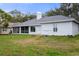 Single-story house exterior with gray siding and landscaping at 810 Sandringham Ln, Lutz, FL 33549