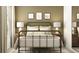 Bedroom with a metal bed frame and light colored bedding at 8549 Bella Mar Trl, Parrish, FL 34219