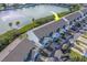 Aerial view showing a waterfront townhouse with parking and surrounding landscape at 905 Hidden Harbour Dr, Indian Rocks Beach, FL 33785