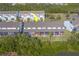 Aerial view showcasing a waterfront townhouse with screened porch and lush landscaping at 905 Hidden Harbour Dr, Indian Rocks Beach, FL 33785