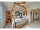 Bedroom with a canopy bed and ocean-themed art at 905 Hidden Harbour Dr, Indian Rocks Beach, FL 33785