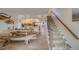 Coastal-themed dining area with a unique wooden table and staircase leading to upper levels at 905 Hidden Harbour Dr, Indian Rocks Beach, FL 33785