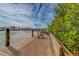 Wooden dock with seating, offering waterfront views at 905 Hidden Harbour Dr, Indian Rocks Beach, FL 33785