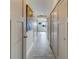 Long hallway with light gray walls and tile flooring at 905 Hidden Harbour Dr, Indian Rocks Beach, FL 33785