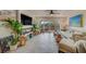 Bright living room with a fireplace, access to deck, and coastal decor at 905 Hidden Harbour Dr, Indian Rocks Beach, FL 33785