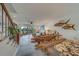 Living room features unique wooden furniture and water views at 905 Hidden Harbour Dr, Indian Rocks Beach, FL 33785