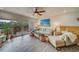 Living area featuring a comfortable sofa and access to a balcony overlooking nature at 905 Hidden Harbour Dr, Indian Rocks Beach, FL 33785