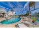 Community pool with lounge chairs and surrounding patio at 905 Hidden Harbour Dr, Indian Rocks Beach, FL 33785