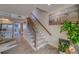 Stylish staircase with wood and carpet runner, view of kitchen and dining area at 905 Hidden Harbour Dr, Indian Rocks Beach, FL 33785