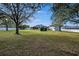 Large grassy backyard with mature trees and privacy fence at 9413 Swift Creek Cir, Dover, FL 33527