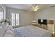 Bright bedroom with a king-size bed, TV, and plenty of natural light at 9413 Swift Creek Cir, Dover, FL 33527