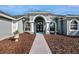 Walkway to the house entrance with landscaping at 9413 Swift Creek Cir, Dover, FL 33527