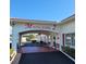 Mainlands 2 community entrance with covered walkway and benches at 9608 41St N St # 2, Pinellas Park, FL 33782