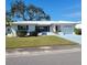 White single story home with blue shutters, attached garage, and well-maintained lawn at 9608 41St N St # 2, Pinellas Park, FL 33782