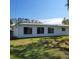 Rear view of the house showcasing a large yard at 9608 41St N St # 2, Pinellas Park, FL 33782