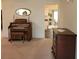 Living room with an organ, chest of drawers, and view into the kitchen at 9608 41St N St # 2, Pinellas Park, FL 33782