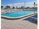 Inviting community pool with surrounding patio and lounge chairs at 9608 41St N St # 2, Pinellas Park, FL 33782