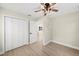 Light-filled bedroom with double door closet and access to hallway at 1104 S Lois Ave, Tampa, FL 33629