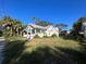 White bungalow home with a side yard at 1105 W De Leon St, Tampa, FL 33606