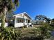 Charming white bungalow home with a spacious front porch at 1105 W De Leon St, Tampa, FL 33606