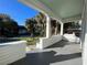 Spacious front porch with grey flooring and white railings, offering a view of the street at 1105 W De Leon St, Tampa, FL 33606