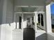 A shaded, partially enclosed front porch with a view of the yard at 1105 W De Leon St, Tampa, FL 33606