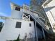 White two-story house with a large back porch and exterior stairs at 1105 W De Leon St, Tampa, FL 33606