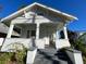 Charming white house with a front porch and steps leading to the entrance at 1105 W De Leon St, Tampa, FL 33606