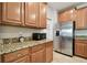 Kitchen boasts granite countertops and stainless steel appliances at 11804 Valhalla Woods Dr, Riverview, FL 33579