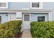 Front entrance of a light blue home with shrubs at 11813 Cypress Hill Cir # 11813, Tampa, FL 33626