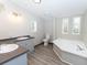 Bathroom with double vanity, soaking tub, and toilet at 12816 Midvale Ave, New Port Richey, FL 34654