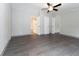 Bright bedroom featuring wood-look floors and ensuite bathroom access at 12816 Midvale Ave, New Port Richey, FL 34654