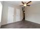 Bedroom with ceiling fan, double closets and wood-look flooring at 12816 Midvale Ave, New Port Richey, FL 34654