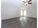 Spacious bedroom with ceiling fan and wood-look flooring at 12816 Midvale Ave, New Port Richey, FL 34654