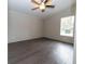 Bedroom with large window, ceiling fan, and wood-look floors at 12816 Midvale Ave, New Port Richey, FL 34654