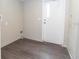 Laundry room with wood-look floors and exterior access at 12816 Midvale Ave, New Port Richey, FL 34654