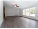 Spacious living room with gray vinyl flooring and ceiling fan at 12816 Midvale Ave, New Port Richey, FL 34654