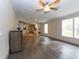Bright living room with wood-look floors and kitchen view at 12816 Midvale Ave, New Port Richey, FL 34654