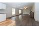 Spacious living room with wood-look floors and large windows at 12816 Midvale Ave, New Port Richey, FL 34654
