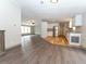 Open living room and kitchen with wood-look flooring throughout at 12816 Midvale Ave, New Port Richey, FL 34654
