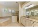 Spa-like bathroom with double vanities and a large shower at 13819 Swiftwater Way, Bradenton, FL 34211