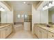 Elegant bathroom with double vanities and a soaking tub at 13819 Swiftwater Way, Bradenton, FL 34211