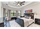 Large main bedroom with a tray ceiling and hardwood floors at 13819 Swiftwater Way, Bradenton, FL 34211