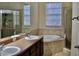 Bathroom boasts a double vanity, soaking tub, and shower at 14003 Citrus Crest Cir, Tampa, FL 33625