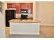 Kitchen with island, granite counters, and dark cabinets at 14003 Citrus Crest Cir, Tampa, FL 33625